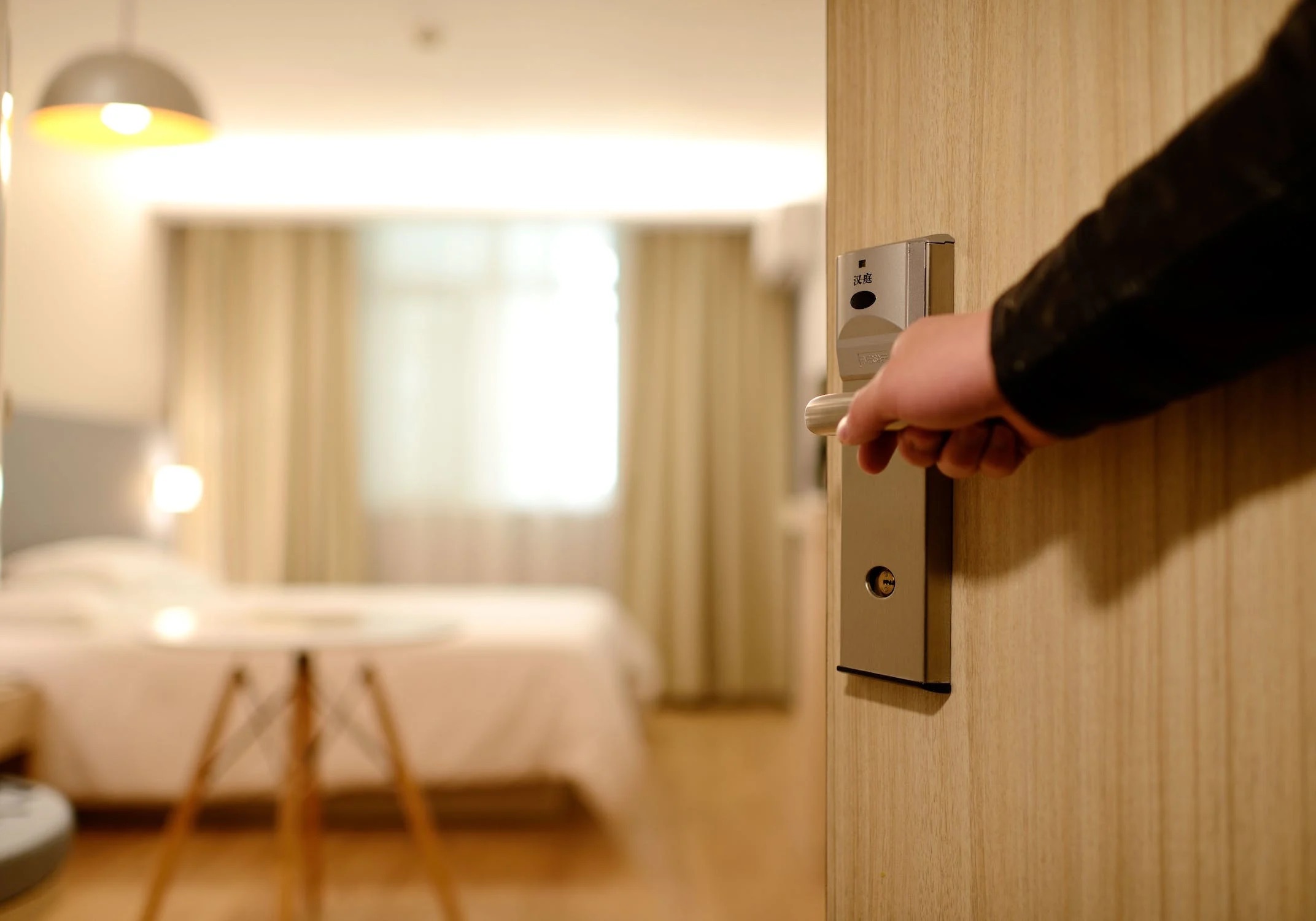 hotels Someone opens the door to a hotel room