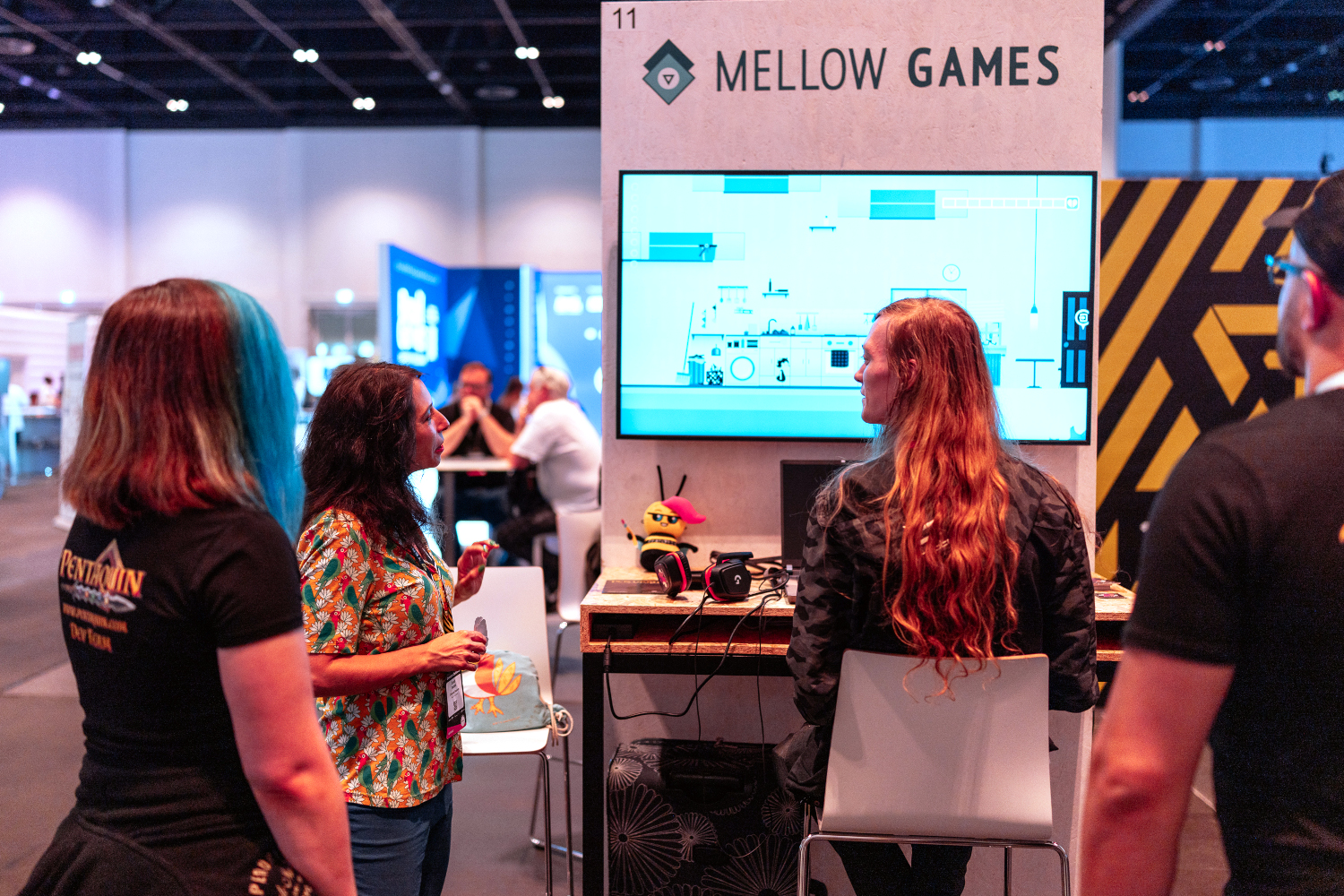 People playing an indie game at a booth